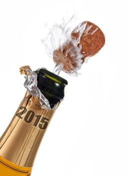 Bottle of champagne splashing open labeled with 2015