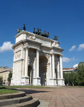 Frontal facade view of Arco della Pace (Arch Of Peace) in a beautiful day with blue sky, Milan, Lombardy, Italy, Europe.