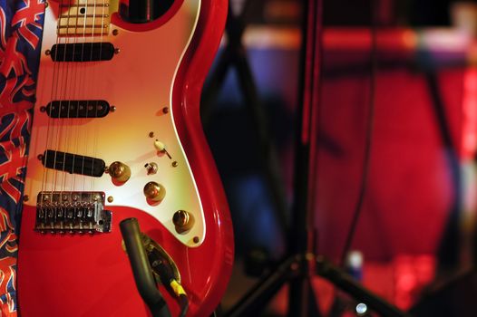 spotlight illuminating a vintage electric guitar on stage