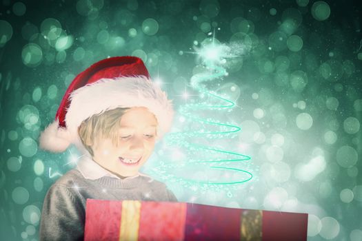 Festive boy opening gift against blue abstract light spot design