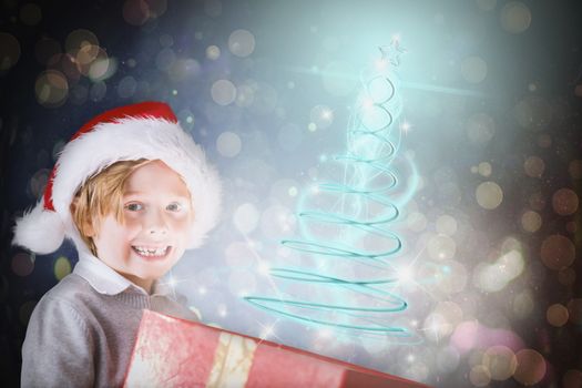 Festive boy opening gift against dark abstract light spot design