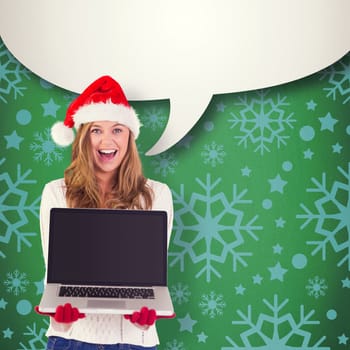 Festive blonde showing a laptop against green vignette