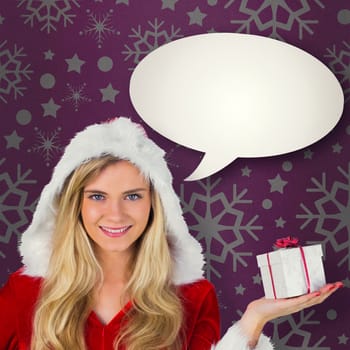 Pretty girl in santa outfit holding gift against pink vignette