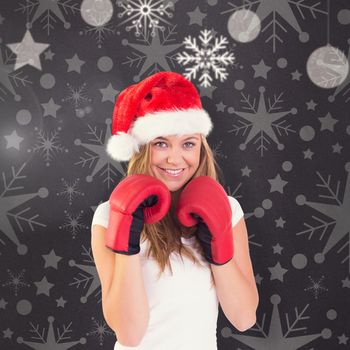 Festive blonde with boxing gloves against grey vignette