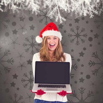 Festive blonde showing a laptop against grey vignette