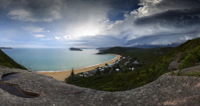 Stitched panorama of the severe storm front that came across the ranges at Broken Bay.  This is a supercell - A supercell is a thunderstorm that is characterized by the presence of a mesocyclone: a deep, persistently rotating updraft formed when cooler airmass underflows the warmer moisture laden air.. A fast moving front, that from first appearance to on top of you was only about five to ten  minutes or less.  The storm had passed over within 20 minutes. Below is Pearl Beach