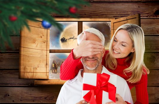 Loving couple with gift against santa delivery presents to village