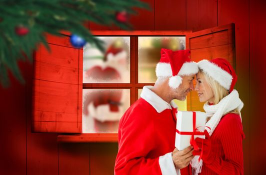 Festive couple against festive fir branch with baubles 