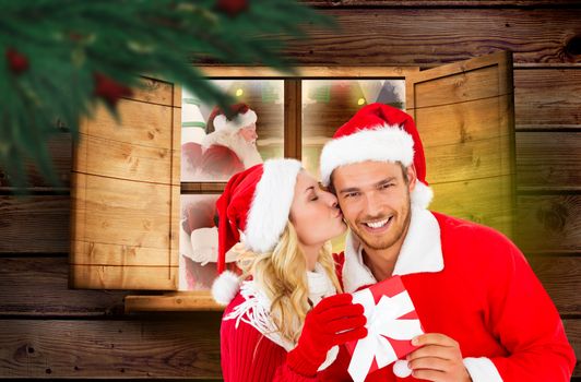 Young festive couple against festive fir branch with baubles 