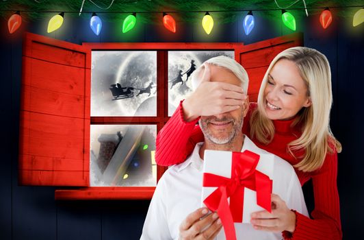 Loving couple with gift against santa delivery presents to village