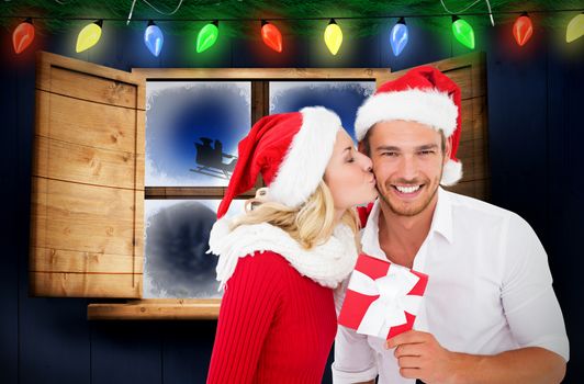 Young festive couple against santa delivery presents to village