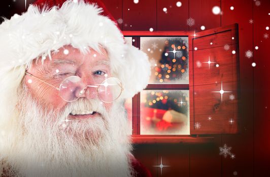Santa claus winking against christmas at home 