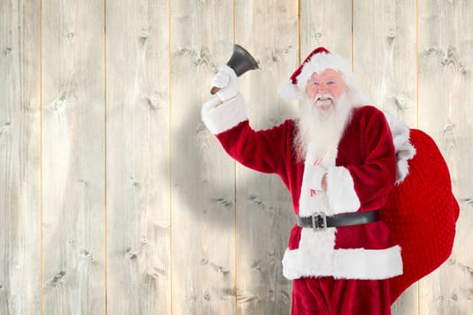 Santa claus ringing bell against pale wooden planks