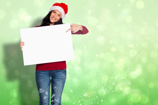 Woman holding a white sign against green abstract light spot design