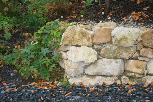 The portion of a dry stone wall in the ornamental garden 