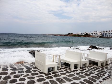 Some white wooden Tables lying almost in the sea, Paros Island, Greece.

Picture taken on August 29, 2011.