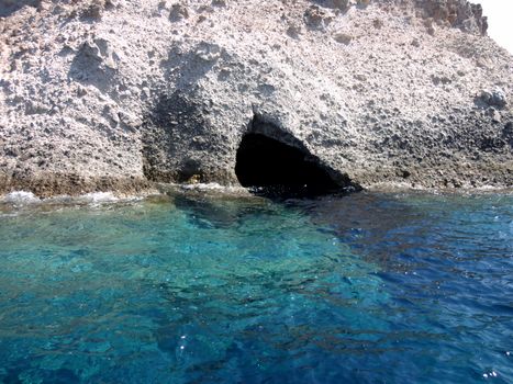 Distant view of a Small cave and crystal clear waters of Paros Island, Greece.

Picture taken on September 1, 2011.