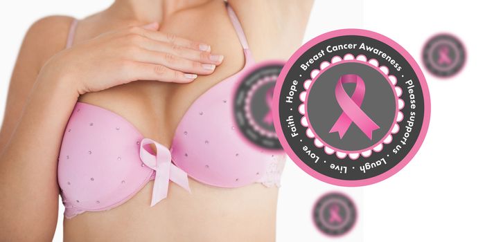 Woman in bra with breast cancer awareness ribbon against pink breast cancer awareness badges