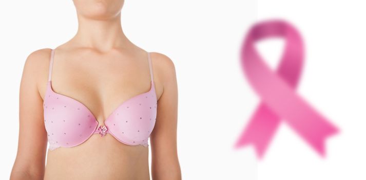 Midsection of woman in pink bra against breast cancer awareness ribbon