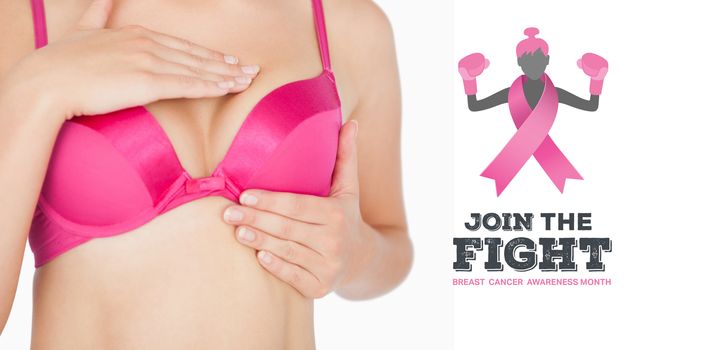 Woman performing self breast examination against breast cancer awareness message