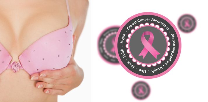 Woman in bra over white background against pink breast cancer awareness badges