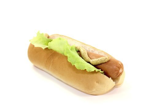 Hot dog with lettuce leaf, sausage and mustard