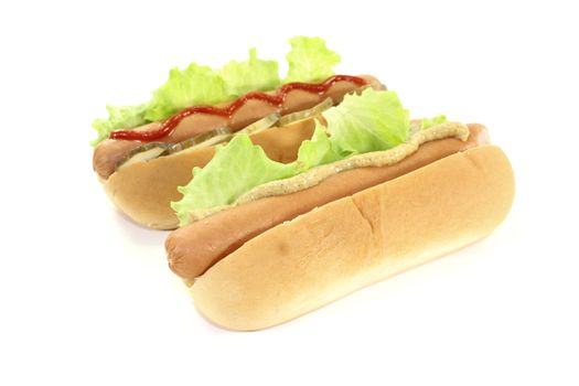 Hot dog with lettuce leaf, sausage, mustard and ketchup