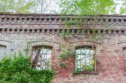 Abandoned factory building. Crumbling Collapsing brick wall, old mortar joints.