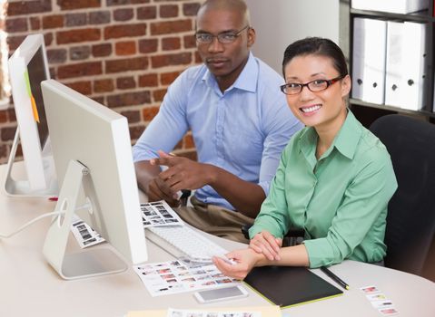 Portrait of smiling photo editors in the office