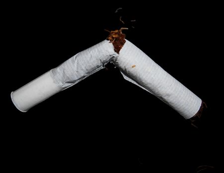 A cut cigarette isolated on black.

Picture taken on November 21, 2014.