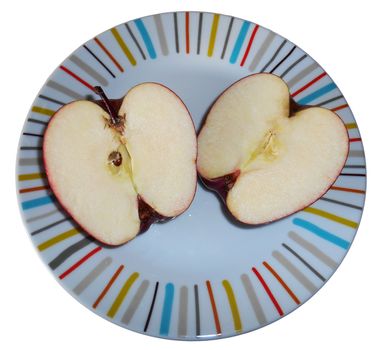 Two halves of an apple on a colourful plate, isolated on white.

Picture taken on November 21, 2014.