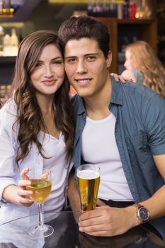 Young couple having a drink together at the bar