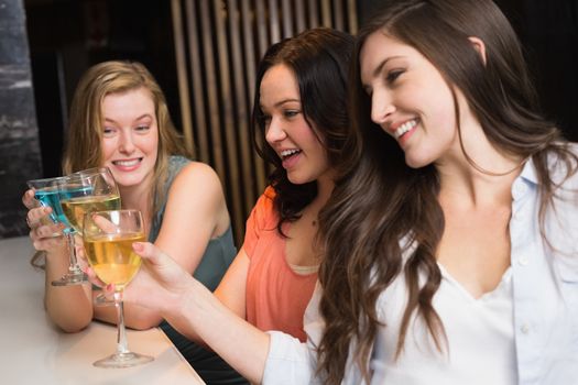 Pretty friends meeting up for a drink at the bar