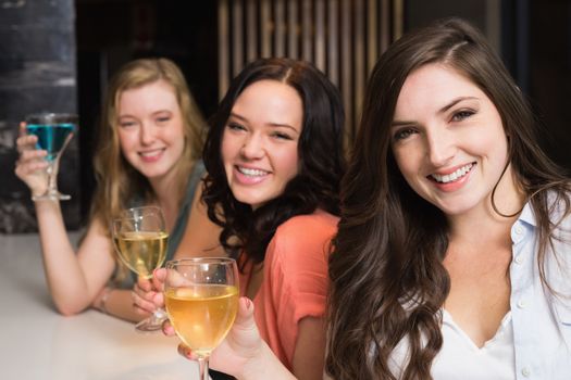 Pretty friends meeting up for a drink at the bar