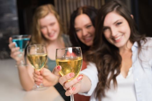 Pretty friends meeting up for a drink at the bar