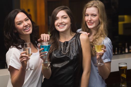 Pretty friends having a drink together at the bar