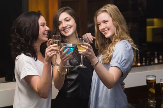 Pretty friends having a drink together at the bar