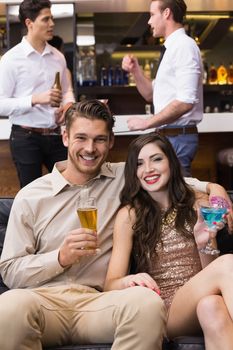 Happy couple having a drink together at the bar