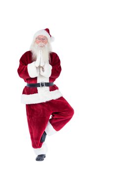 Father Christmas doing some yoga on white background