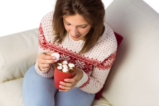 Brunette in winter fashion holding mug at home in the living room