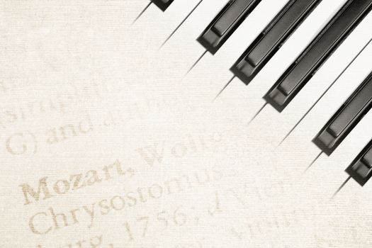 background of mozart text on antique paper with piano keys
