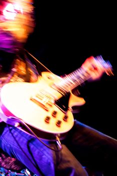motion blur abstract of a rock guitarist with a golden guitar