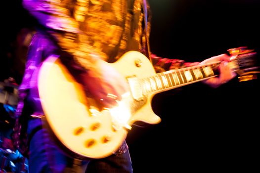 motion blur abstract of a glam rock guitarist wearing glitter clothing