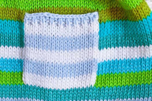 Close up of the pocket  of a babies' jumper