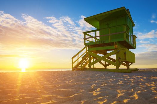 Miami South Beach sunrise with lifeguard tower and coastline, USA.