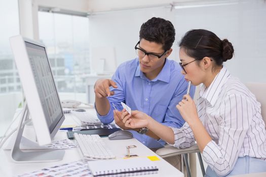 Creative team working at desk in creative office