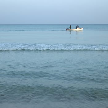 Men on boats on the tropical ocean