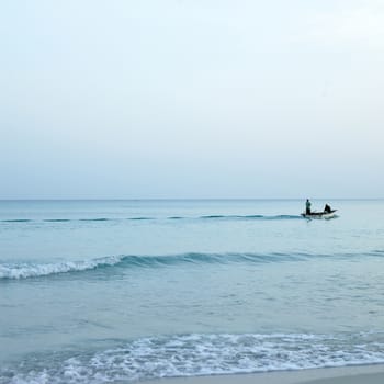 Men on boats on the tropical ocean