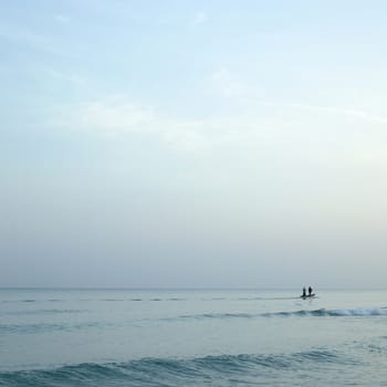 Men on boats on the tropical ocean