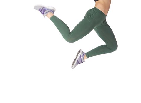 Legs of jumping sportive woman on a white background